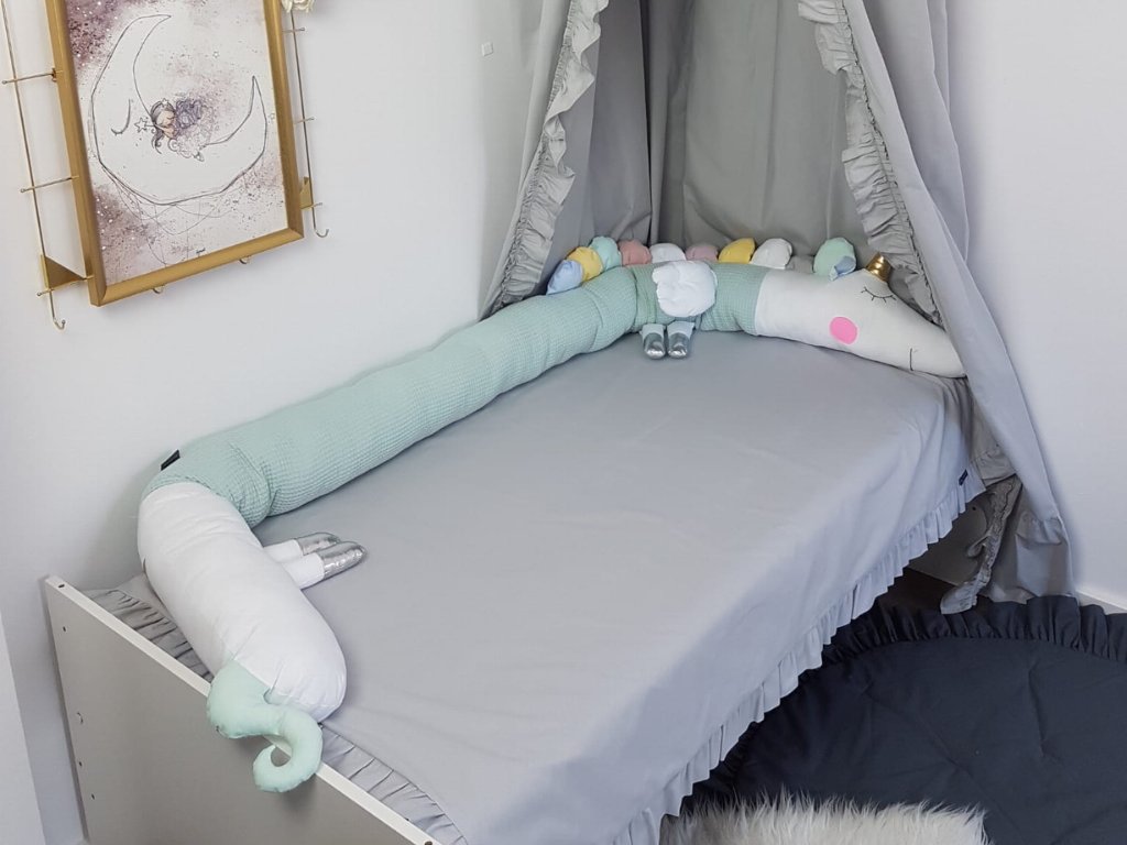 A hand sewn cotton crib bumper with a UNICORN design will protect