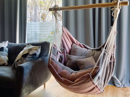 Fabric rocking chair for hanging in the interior in pink-gray color